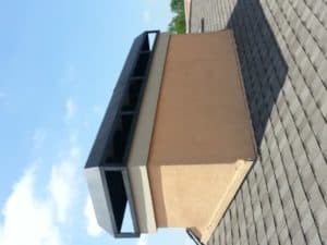 Chimney cap Installed on Tan Roofing