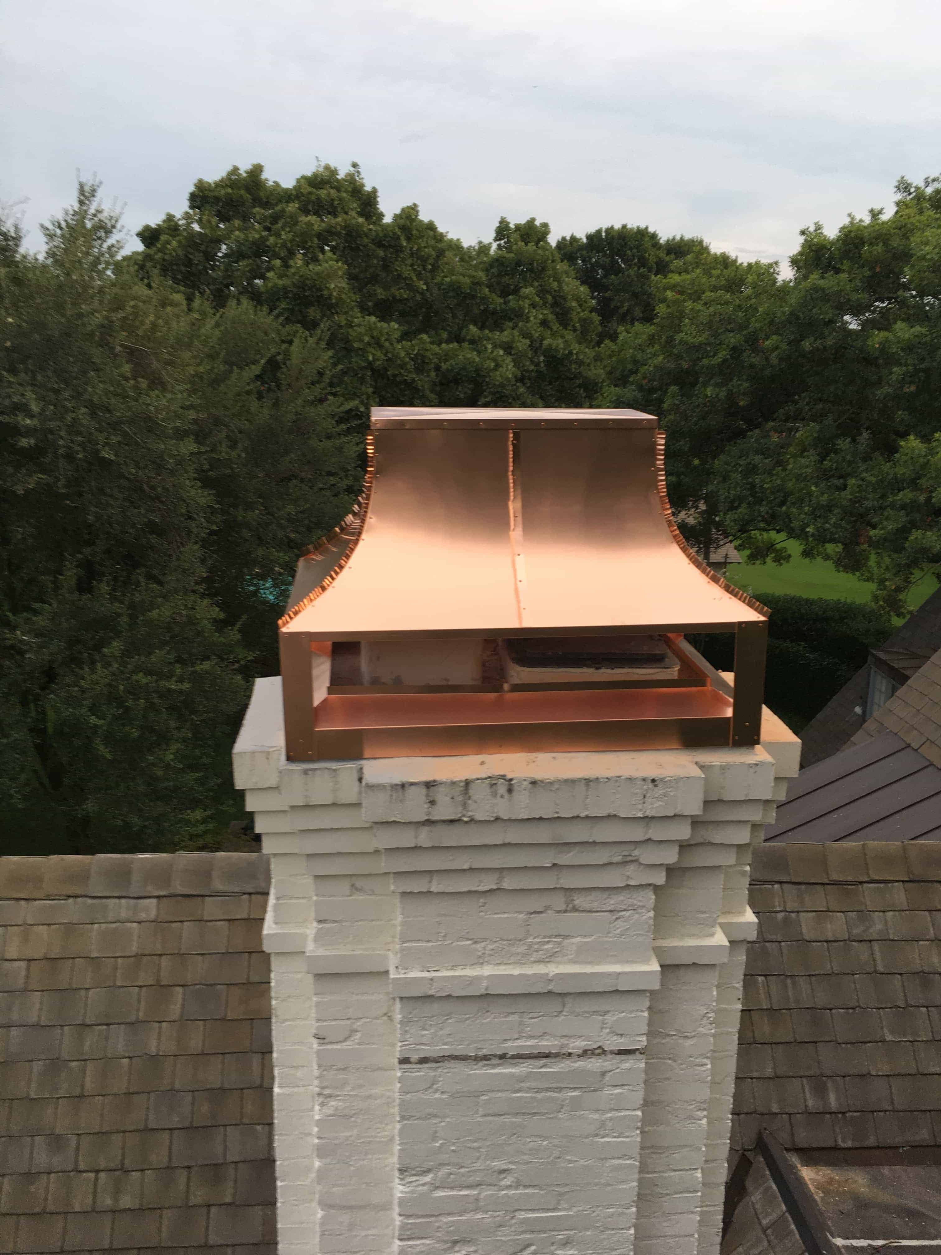 Copper Hayes Chimney Cap Installed on White Brick