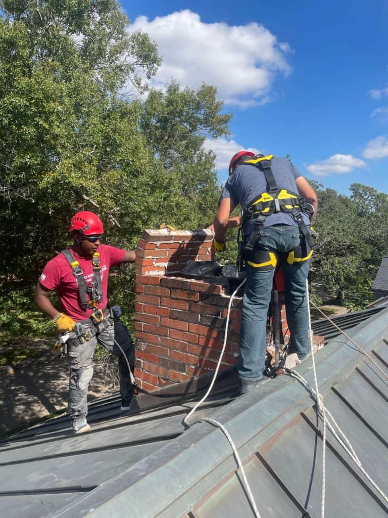 Crew of our Chimney professionals completing chimney services on a masonry chimney that has suffered from water damage. Home located in Dallas, TX