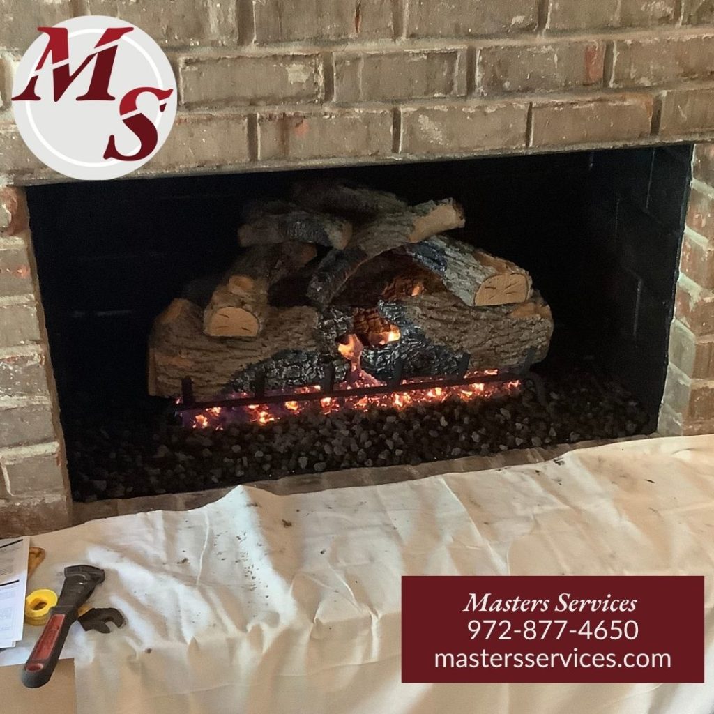 Gas Fireplace Log Set installed by Masters Services in Charred Oak burning in fireplace