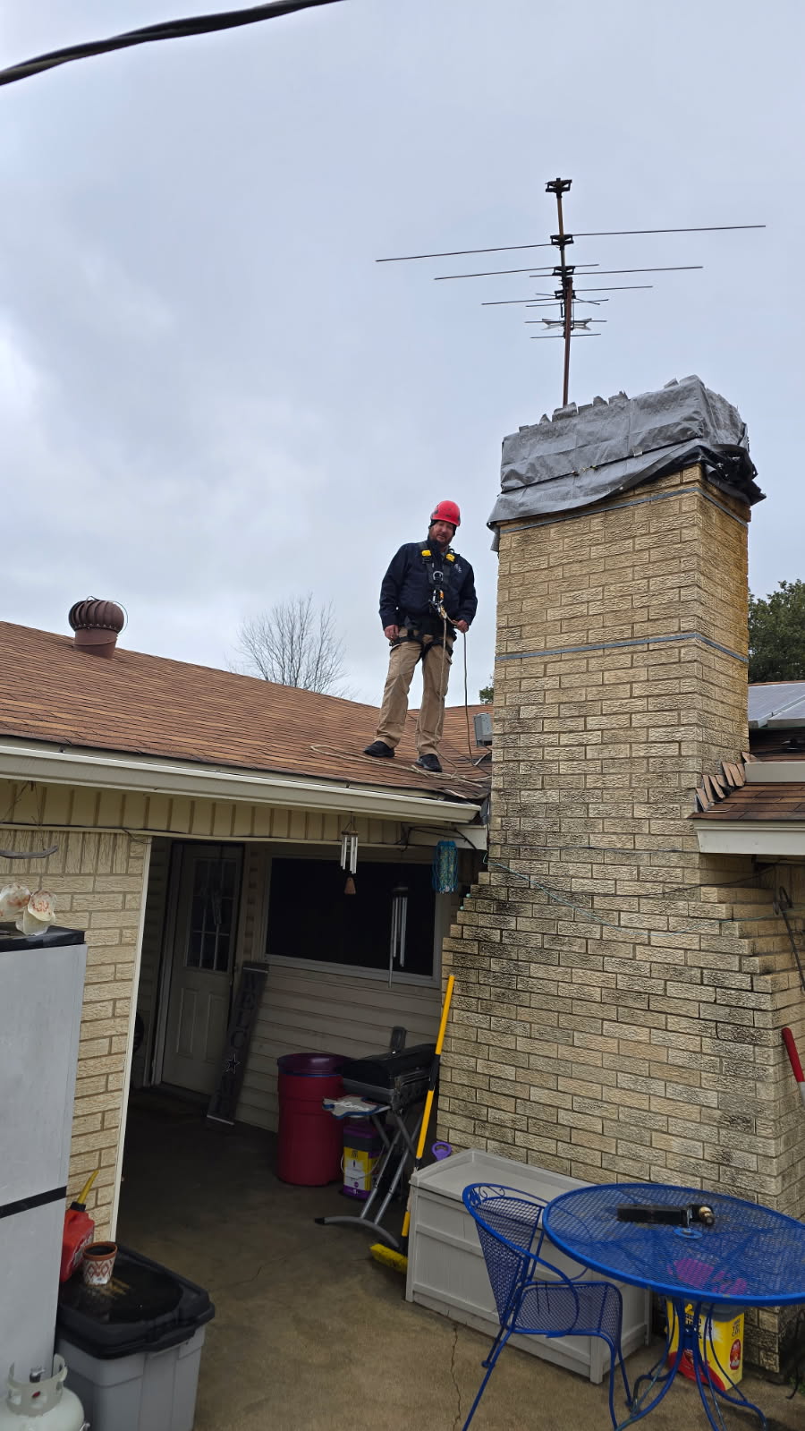 Dallas Chimney Sweep putting tarp on chimney top before repairs