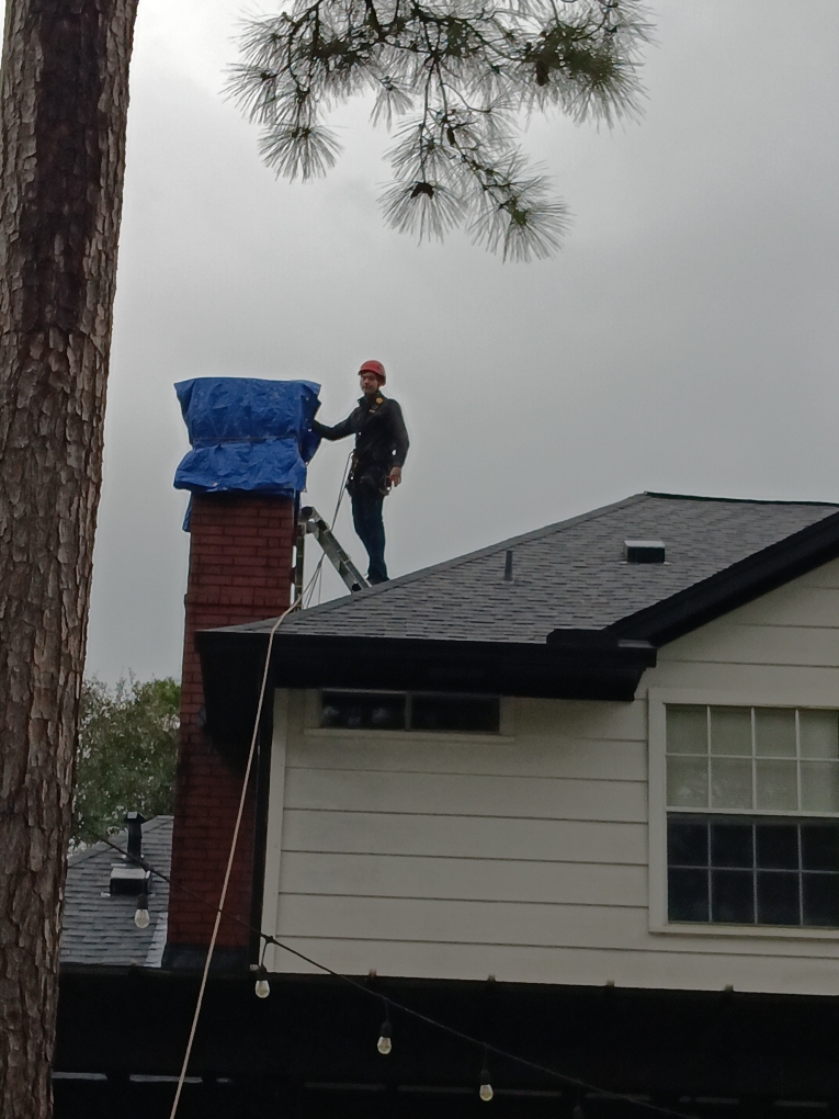 Dallas Chimney Sweep inspecting masonry chimney exterior during an annual Inspection