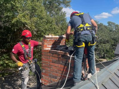 Crew of our Chimney professionals completing chimney services on a masonry chimney that has suffered from water damage. Home located in Dallas, TX